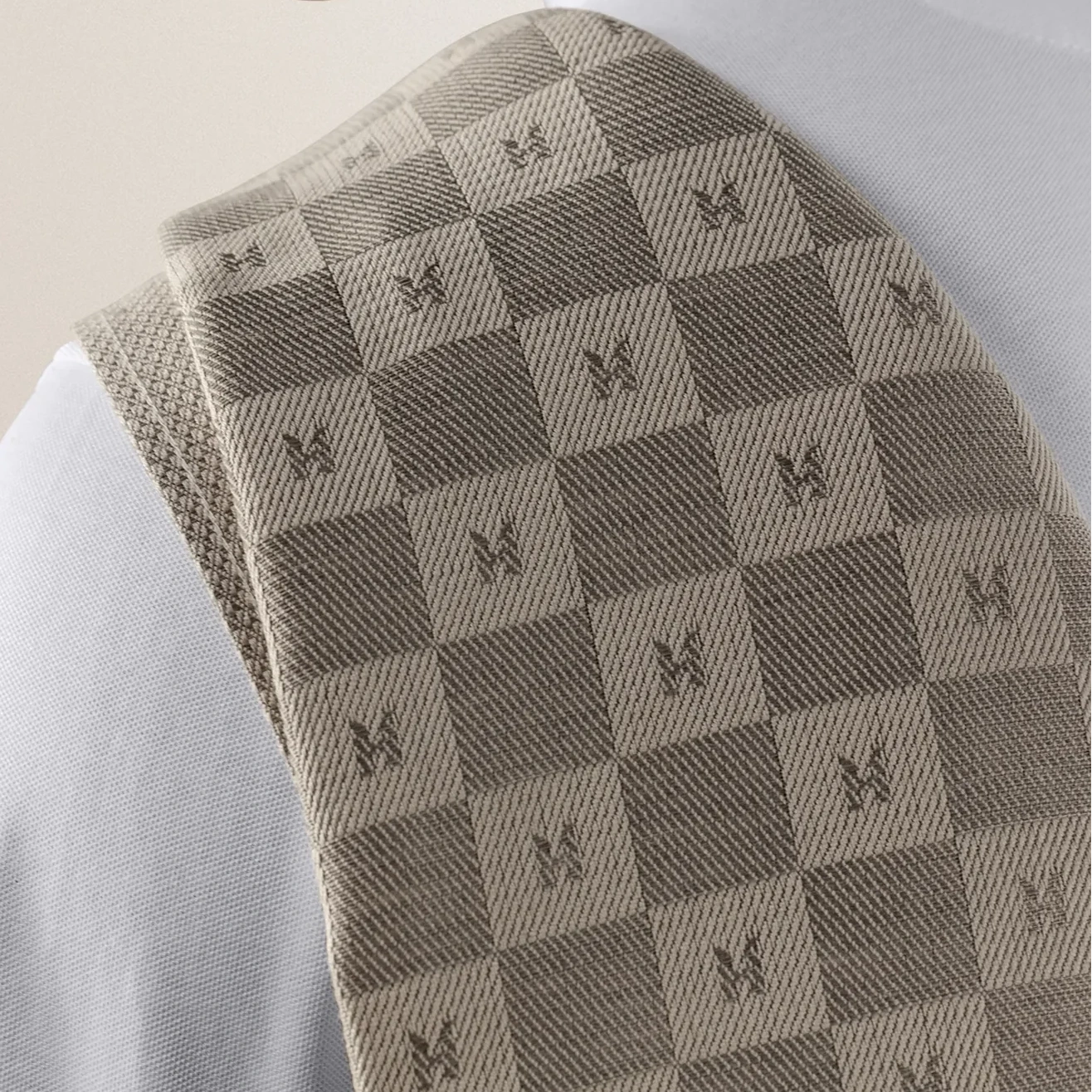 Gray checkered tie with a pattern on a light gray background